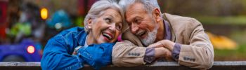 man and woman laughing together outside