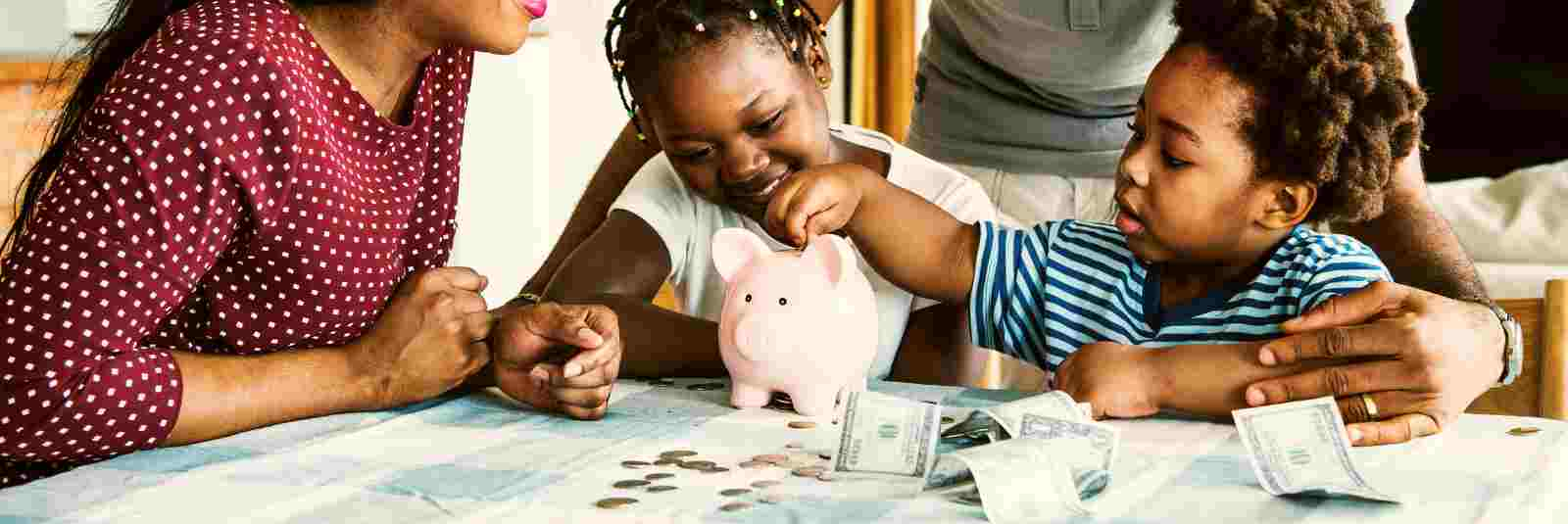 family saving money in piggy bank