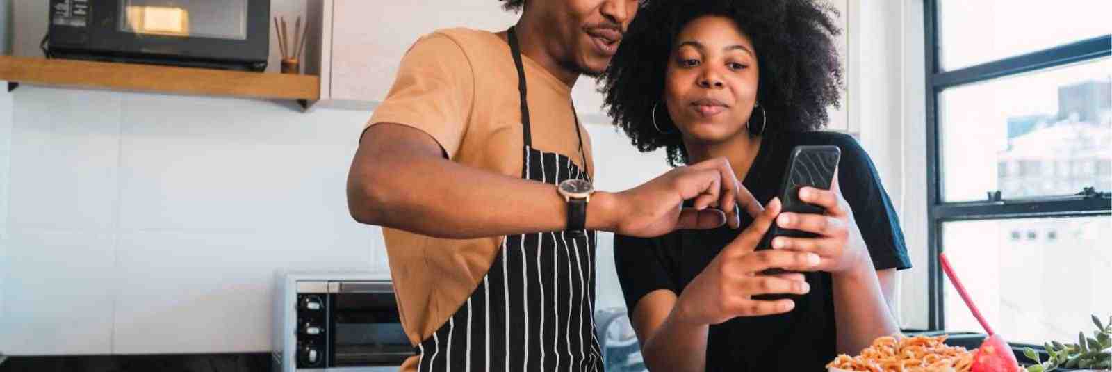 couple looks at recipe on phone