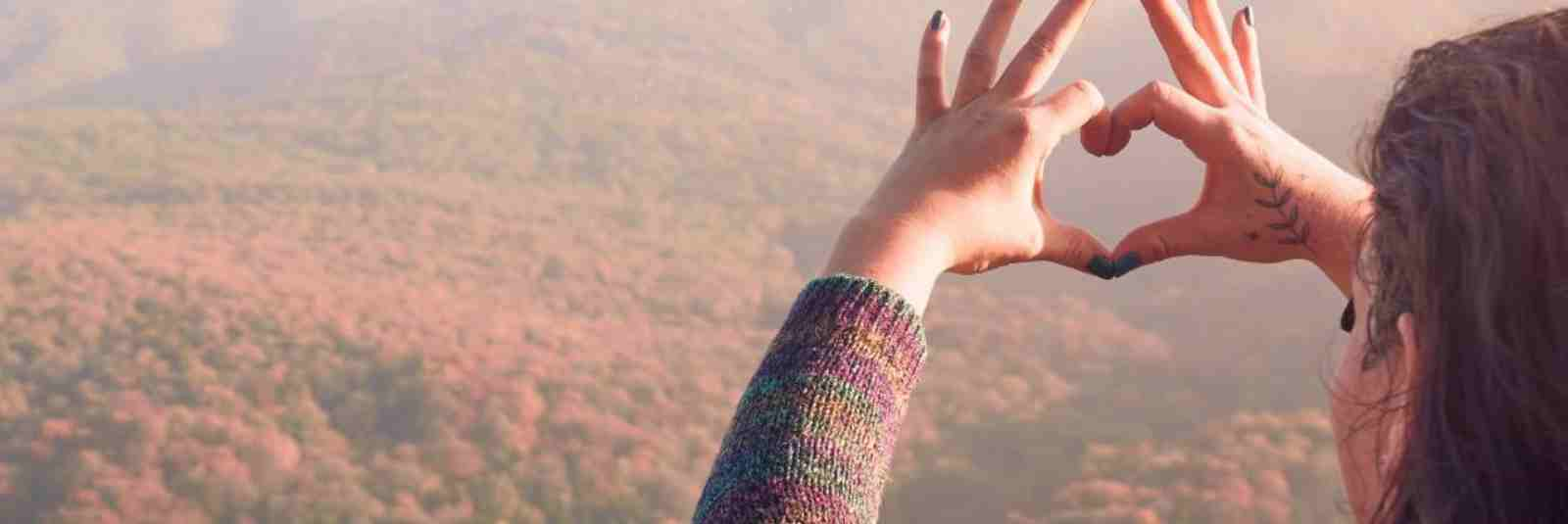 woman making hands into a heart