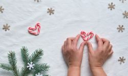 person making heart with candy canes