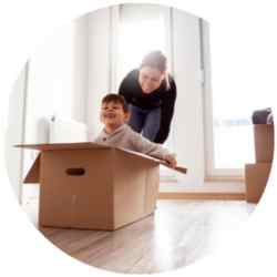 woman pulling around a kid in a moving box