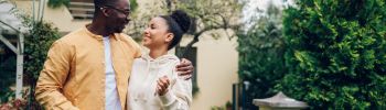 Couple standing front first home