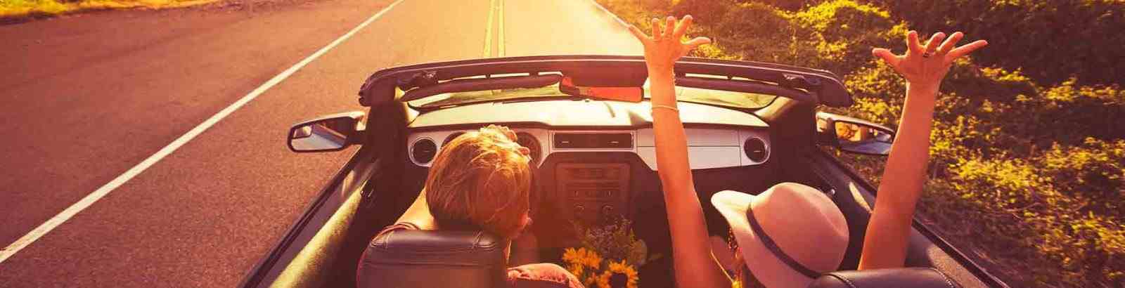 couple driving in convertible