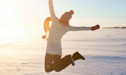 woman jumping in air during winter