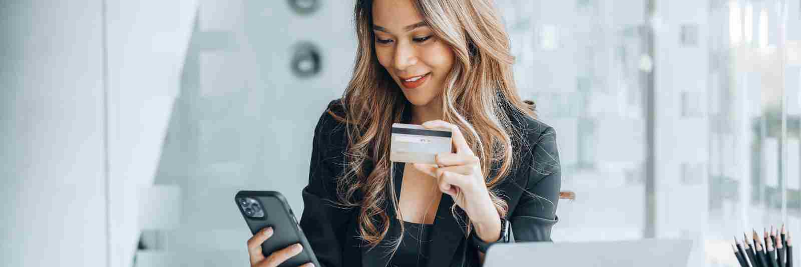 business owner using her phone and credit card