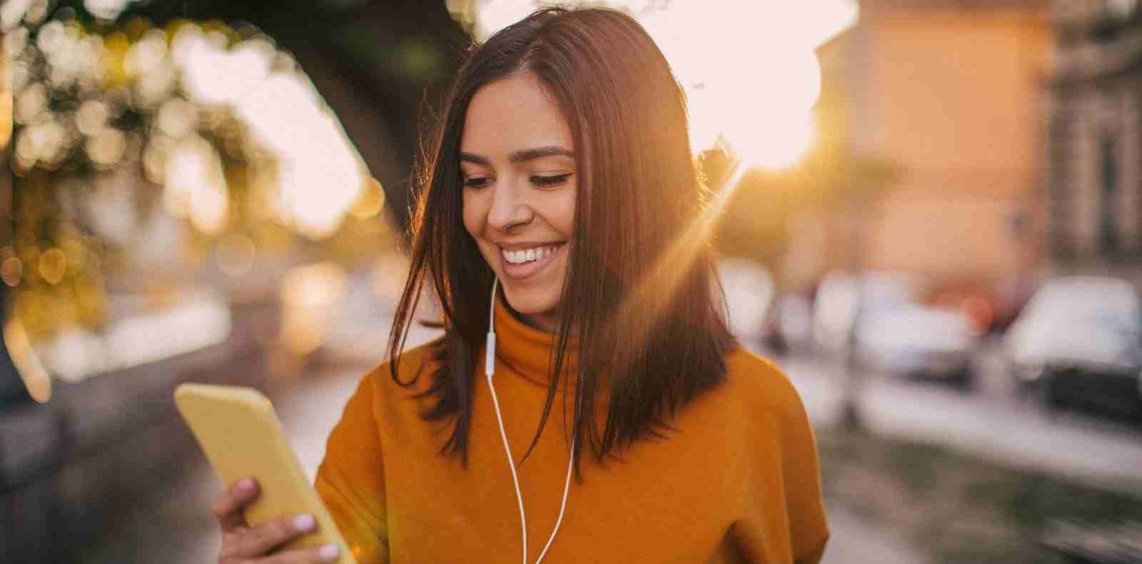 Woman walking and listening to headphones