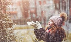 little girl catching snow