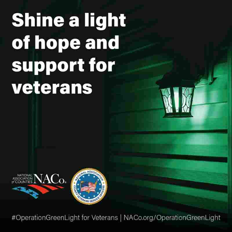 Shine a light of hope and support for veterans. green light lite up on porch.