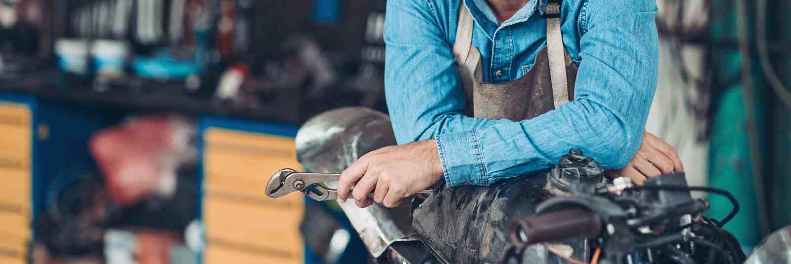 mechanic leaning on motor