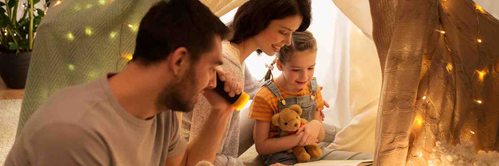 Family reading inside tent - large version